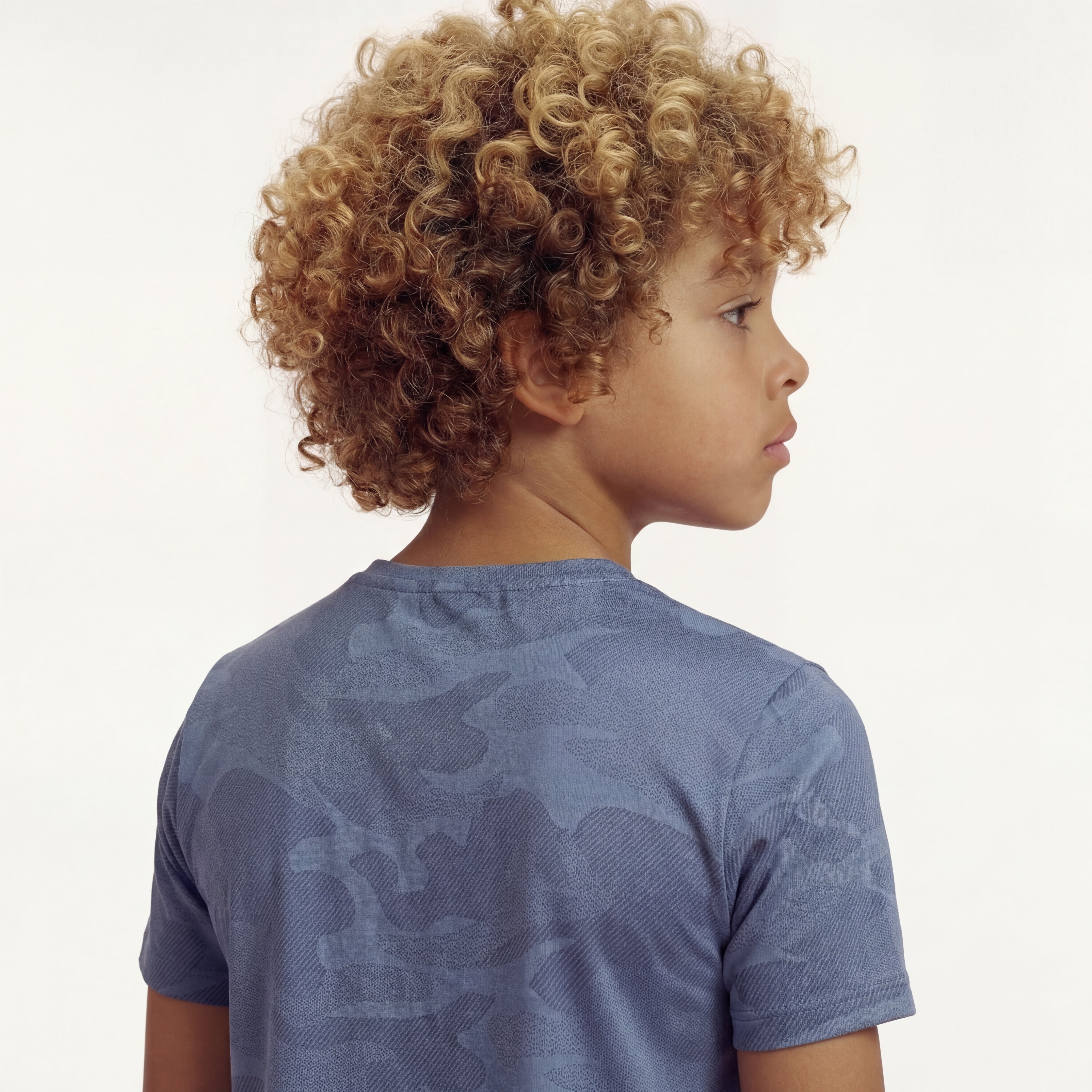 Back close-up view of a boy wearing a regular fit vintage indigo camo t-shirt.