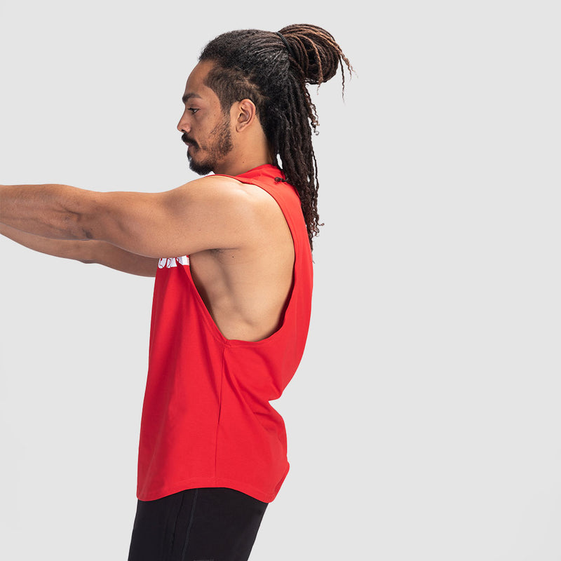 a fit man stand at right and wearing tank  high risk red with pants black 
