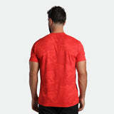 a back view for fit man wearing t-shirt high risk red plus the pants black 