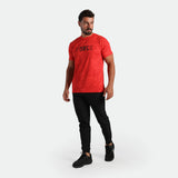 Man wearing a red 'FORCE' t-shirt and black pants ,plus the shoes 