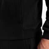 close up view for tow pocket of matching set black ,hoodie and pants 