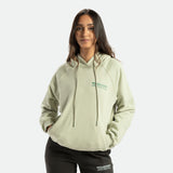 a fit woman wearing hoodie green with pants olive 