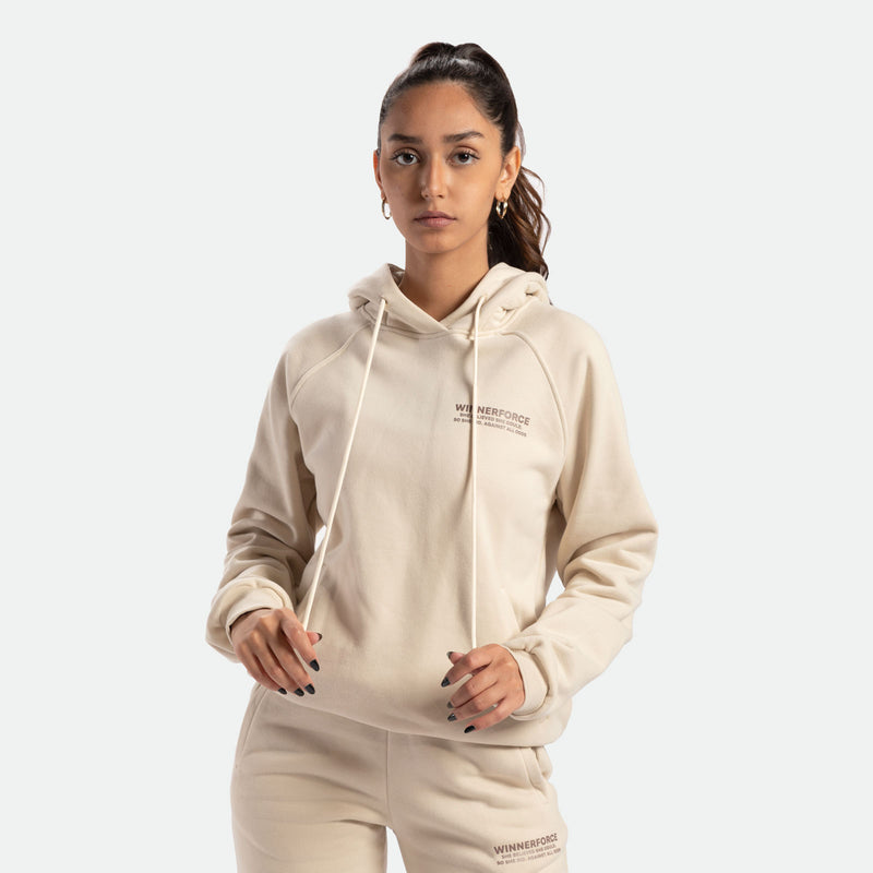 a fit woman wearing  hoodie  and pants beige 