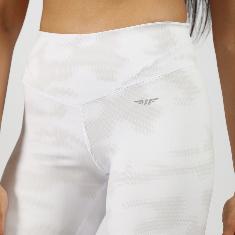 a fit woman wearing legging illuminated white  with logo grey ,the background is light grey 