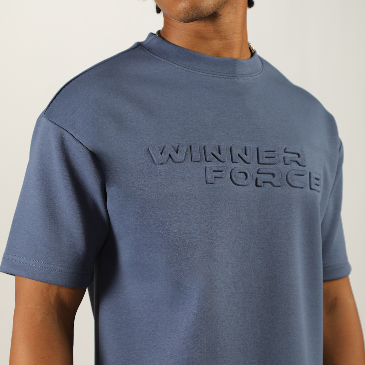 close up view for fit man wearing t-shirt indigo blue with logo 