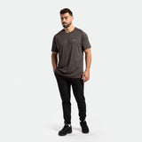 a fit man wearing t-shirt dark grey  with pants black ,plus shoes black 