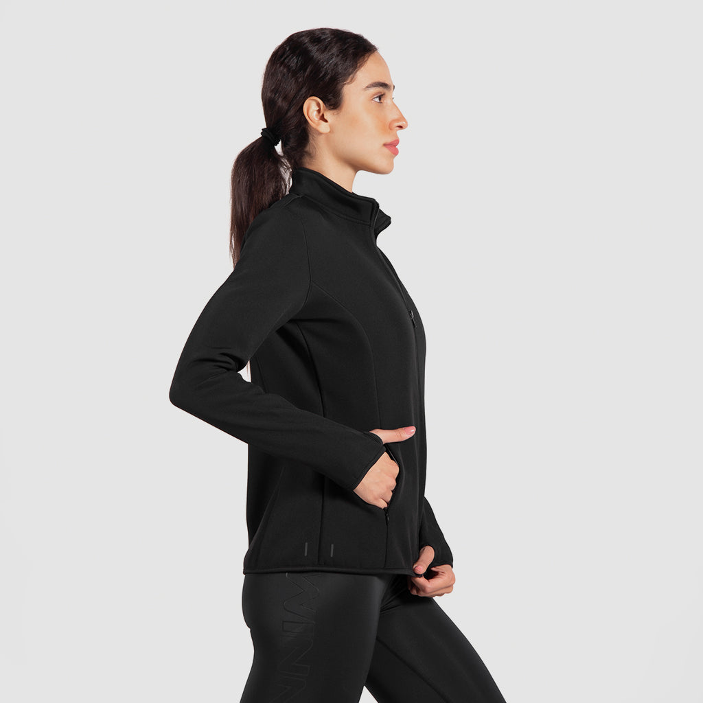a it woman stand at right and wearing matching set  jacket and legging 