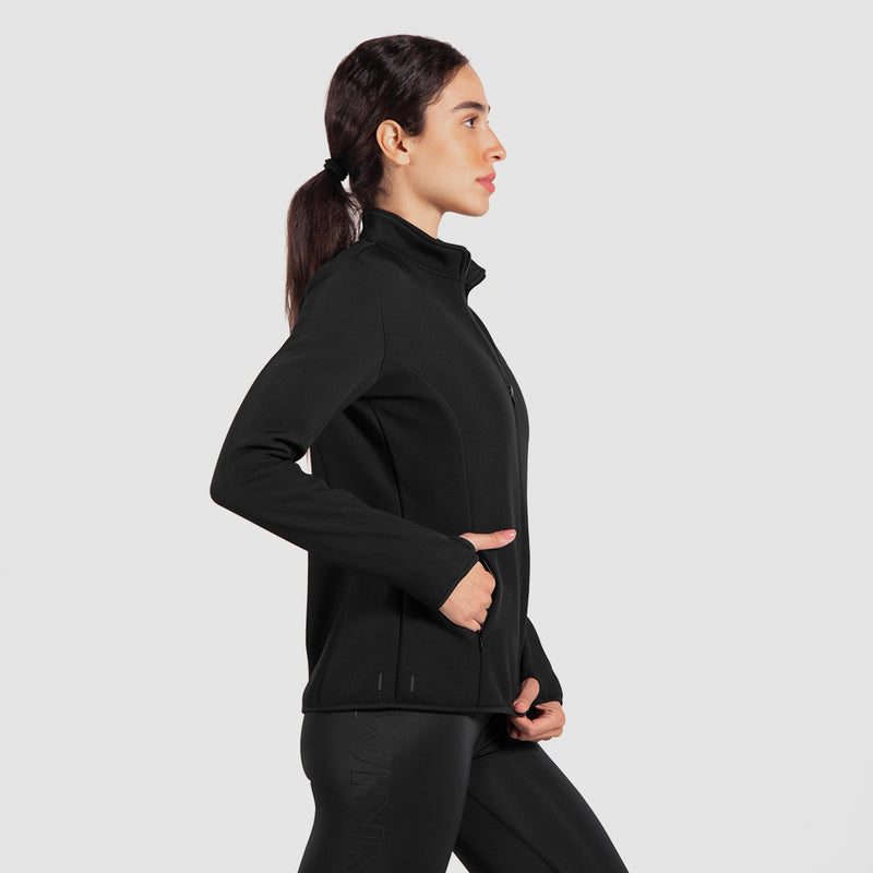 a it woman stand at right and wearing matching set  jacket and legging 