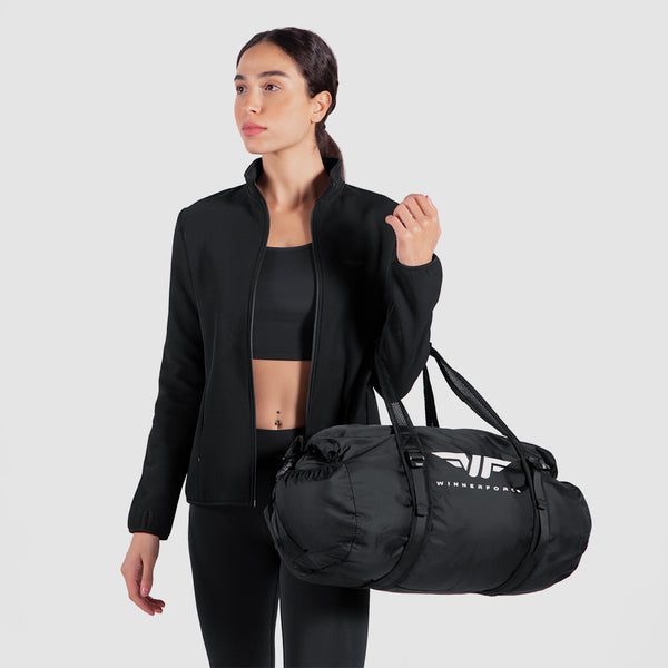 a fit woman wearing  matching  color black bra and jacket  and legging and bag 