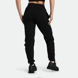 a back view for fit woman wearing jogger pants black ,plus the shoes 