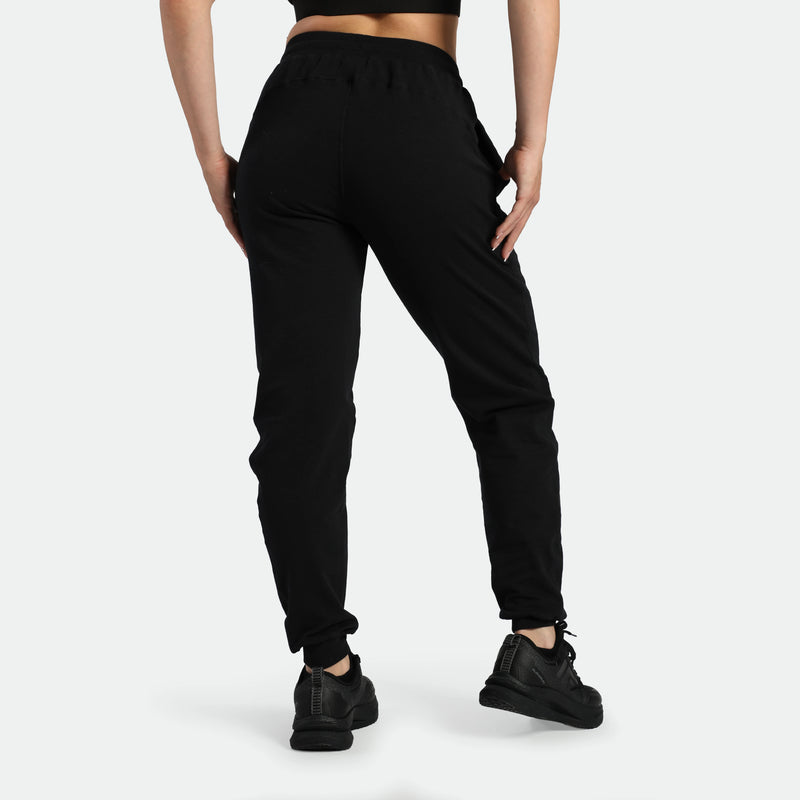 a back view for fit woman wearing jogger pants black ,plus the shoes 