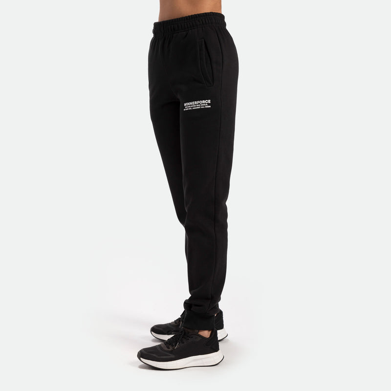 a fit woman stand at right ,and wearing  jogger pants with logo white, she wearing black shoes athletic 