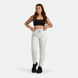 a fit man wearing crop top black with pants cloud grey ,plus the shoes black 
