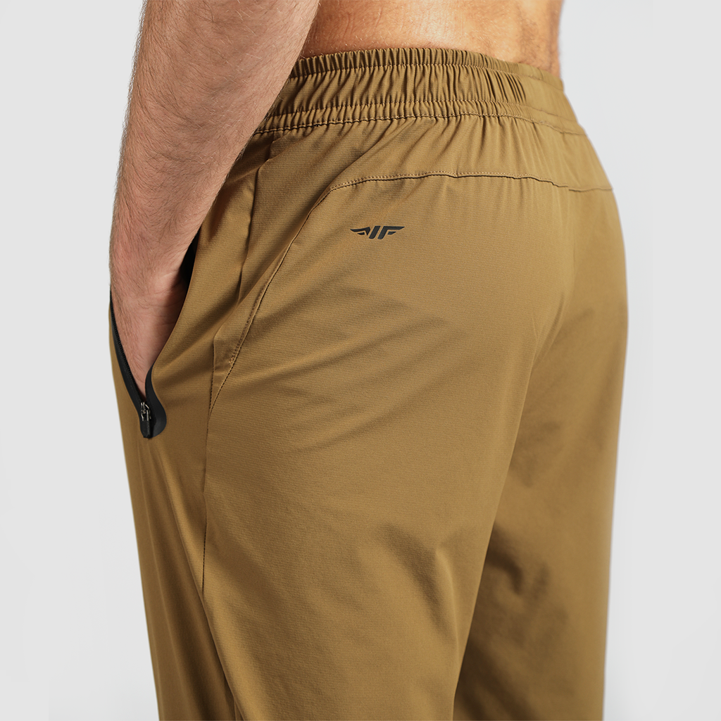 a back view for fit man wearing pants khaki  browns with logo 