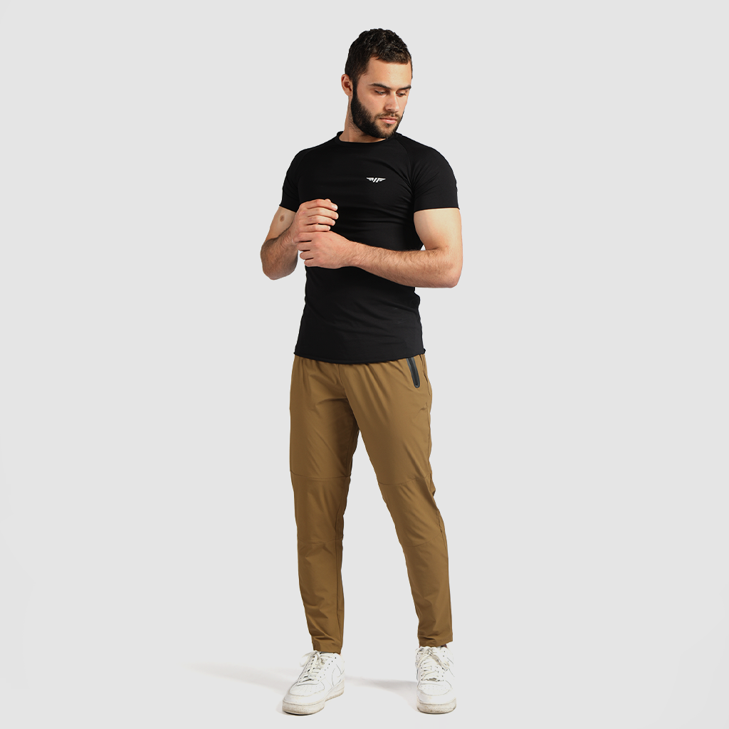 a fit man wearing t-shirt black with pants khaki  browns with shoes white  