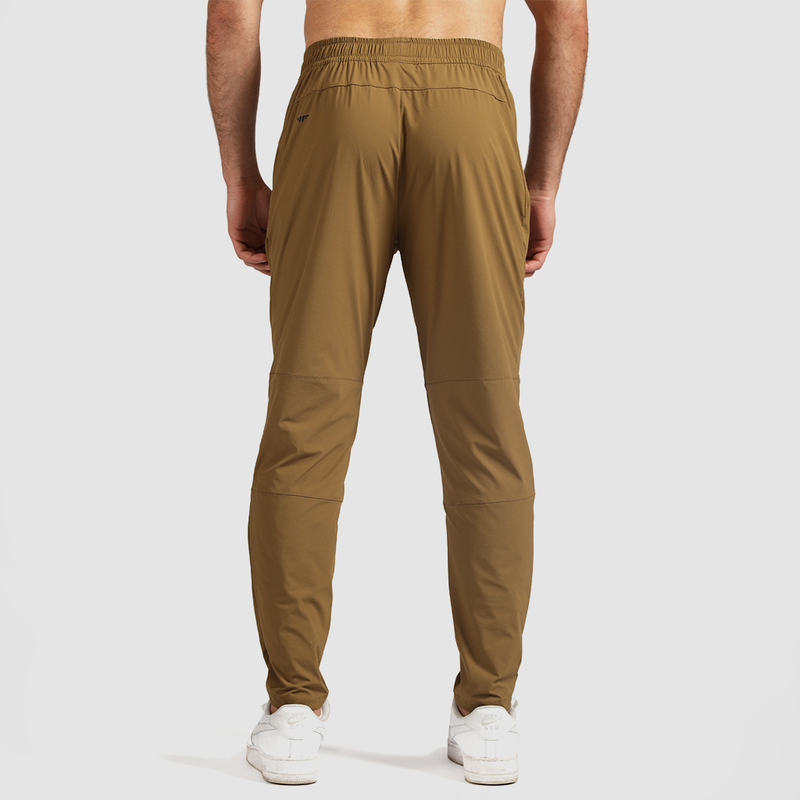 a back view for fit man wearing pants khaki with shoes white  