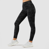 a fit woman wearing camo legging with logo  dark grey ,and wearing shoe white ,plus background light grey 