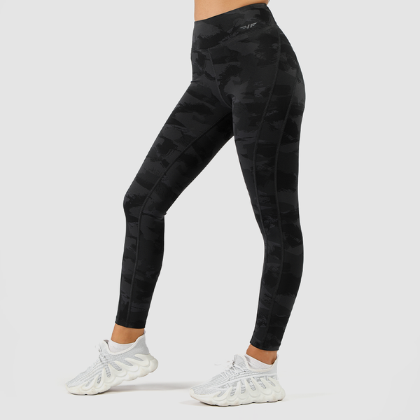 a fit woman wearing camo legging with logo  dark grey ,and wearing shoe white ,plus background light grey 