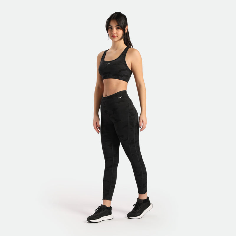 a fit woman wearing matching camo legging and bra with logo light grey ,