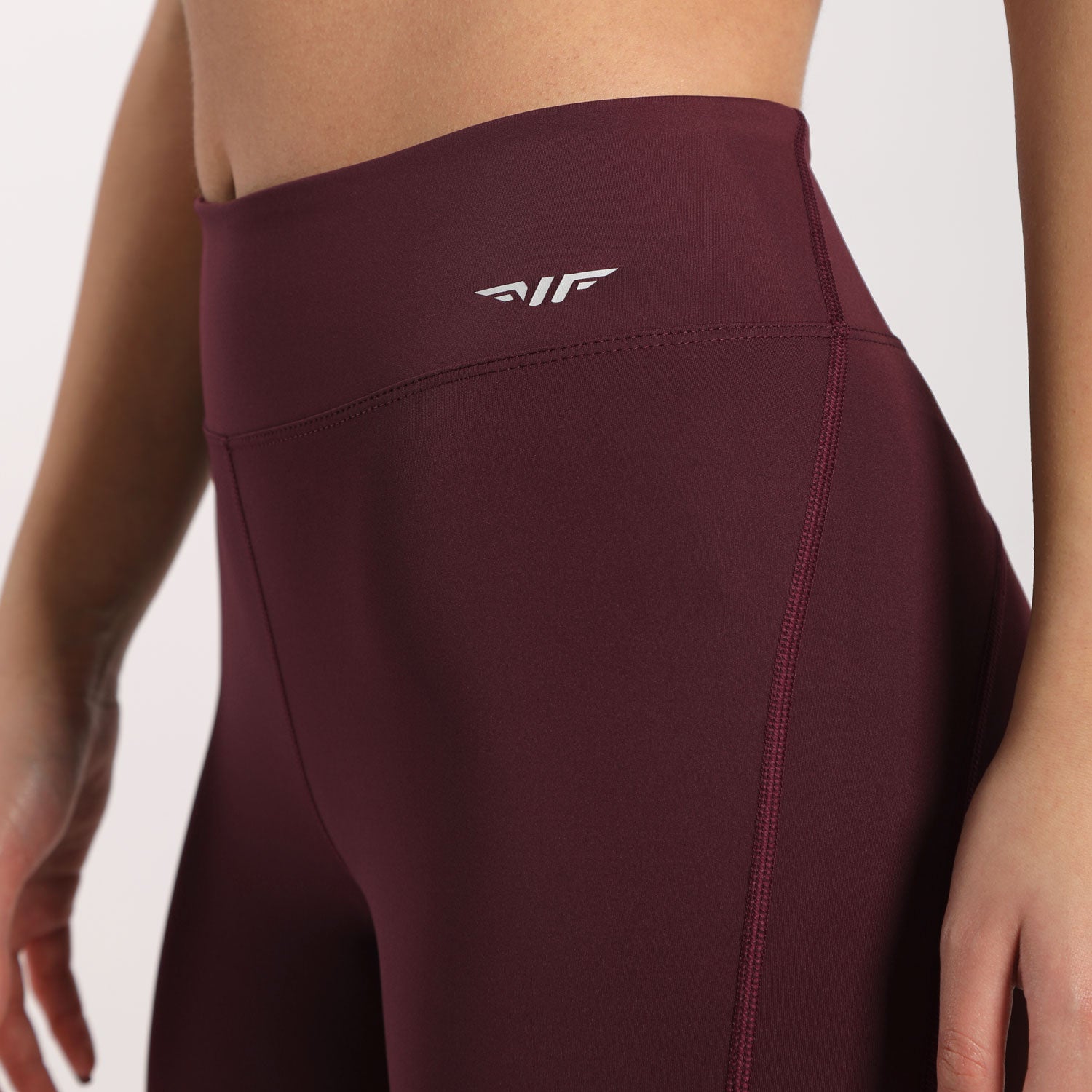  a fit woman wearing legging red with logo white, plus background light grey