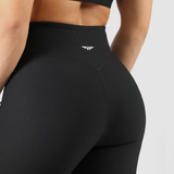 a back view for woman wearing legging black with logo white, the background is light grey 
