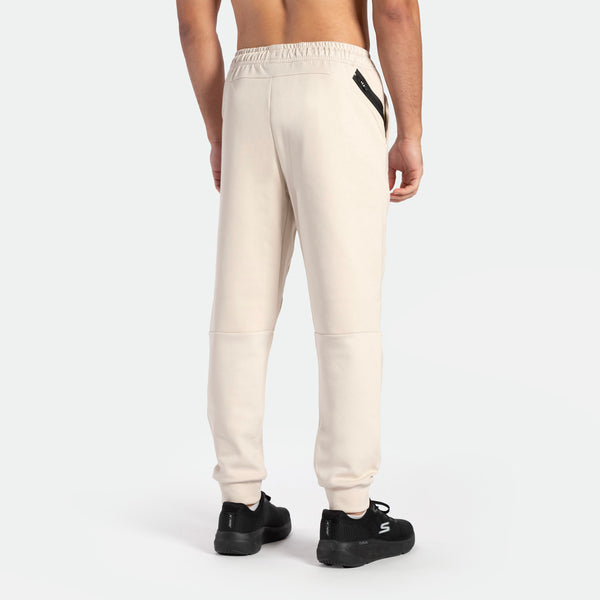 a back view for fit man wearing pants cargo light beige with shoes black 