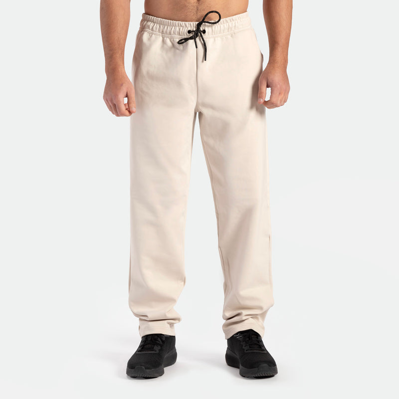 a fit man wearing  pants beige with shoes black 