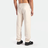 a back view for fit man wearing  pants beige with shoes back 