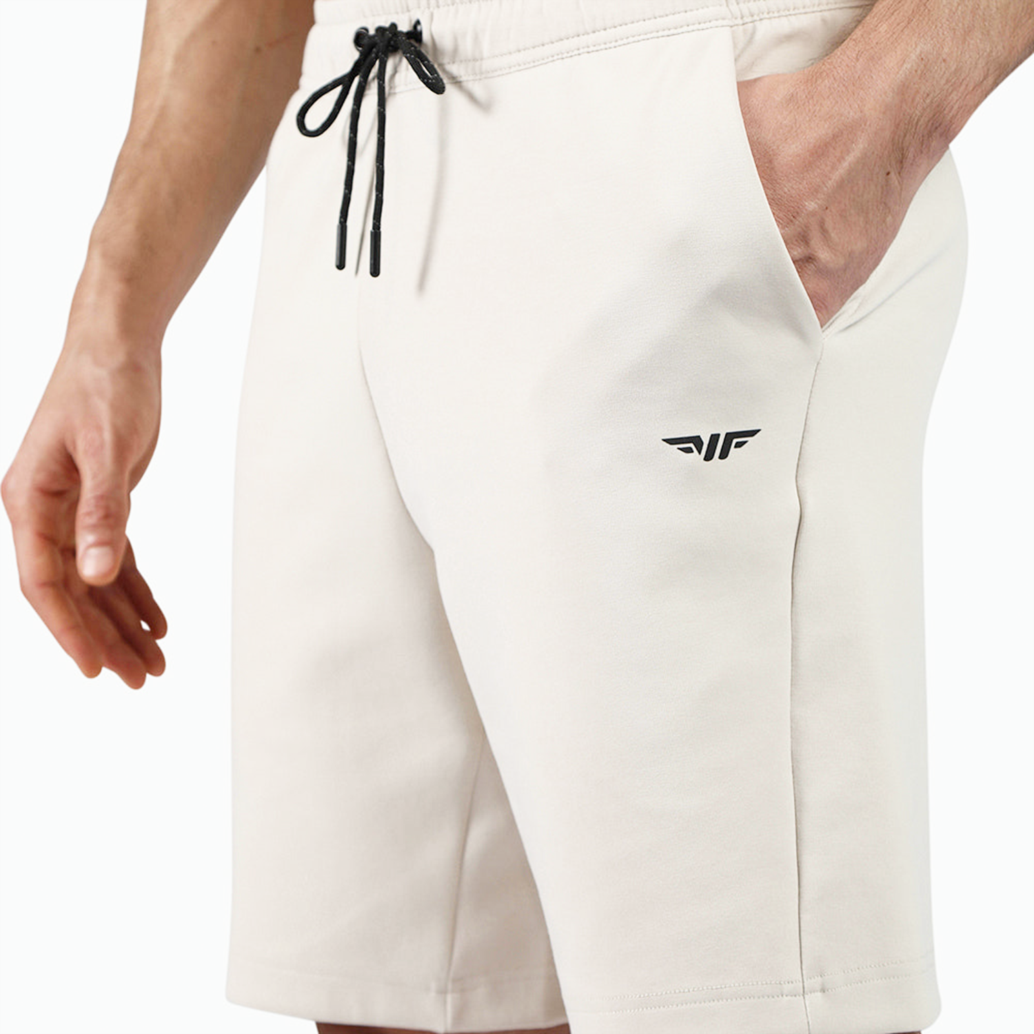close up view for fit man wearing short light beige with  logo 