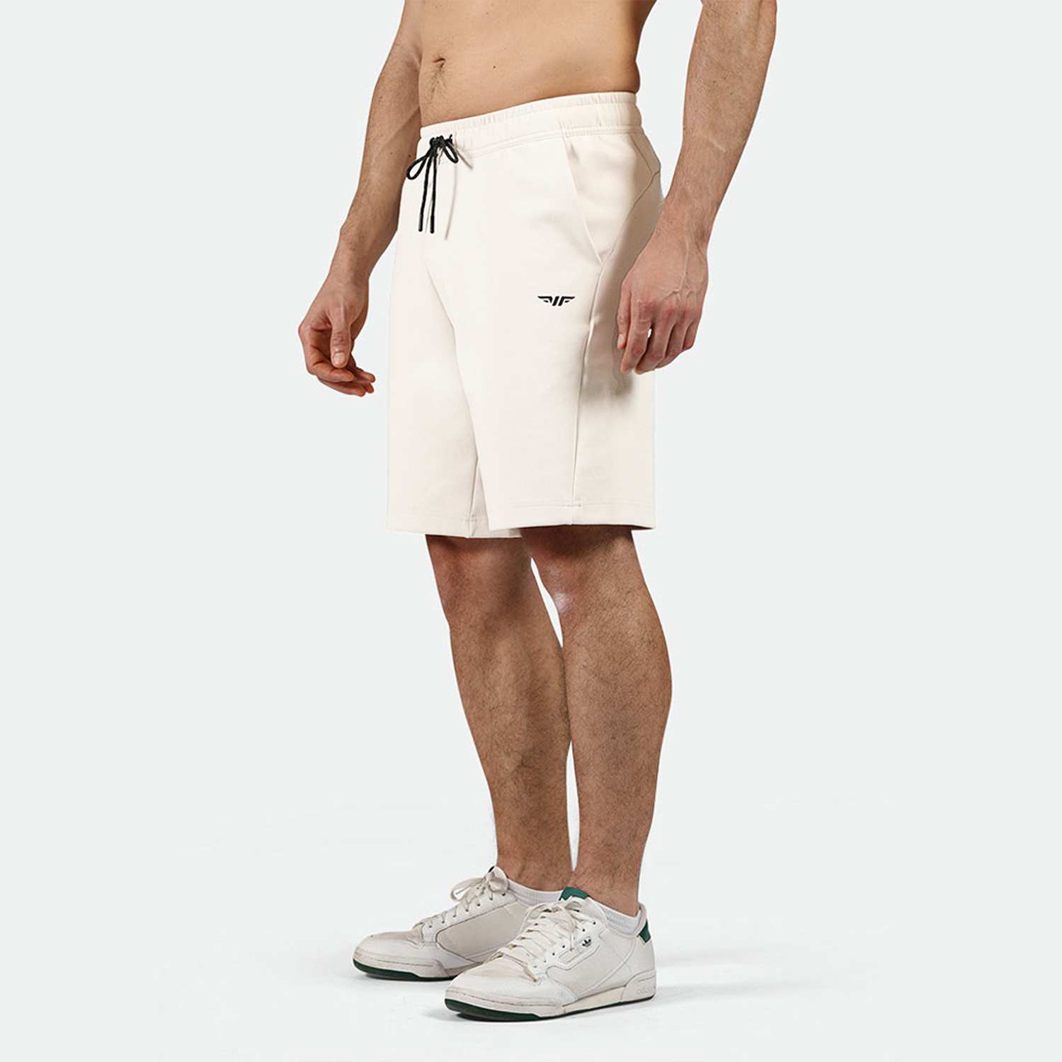 a fit man wearing short beige ,plus the shoes 