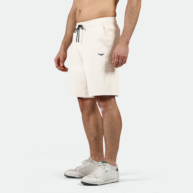 a fit man wearing short beige ,plus the shoes 