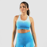 a fit woman wearing matching bra and legging a blue gradien and logo white ,the background is light grey 