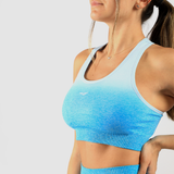 a woman wearing bra a blue gradien  with logo ,the background is light grey 