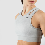 a women wearing sport bra grey ,plus logo 