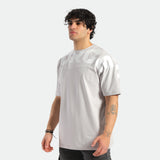 a fit man stand at right and wearing t-shirt light grey with logo ,plus he wearing  pants black 