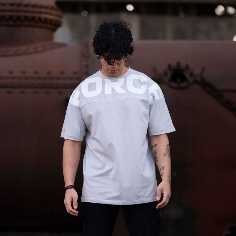 a fit man wearing t-shirt  light grey with logo and pants back 