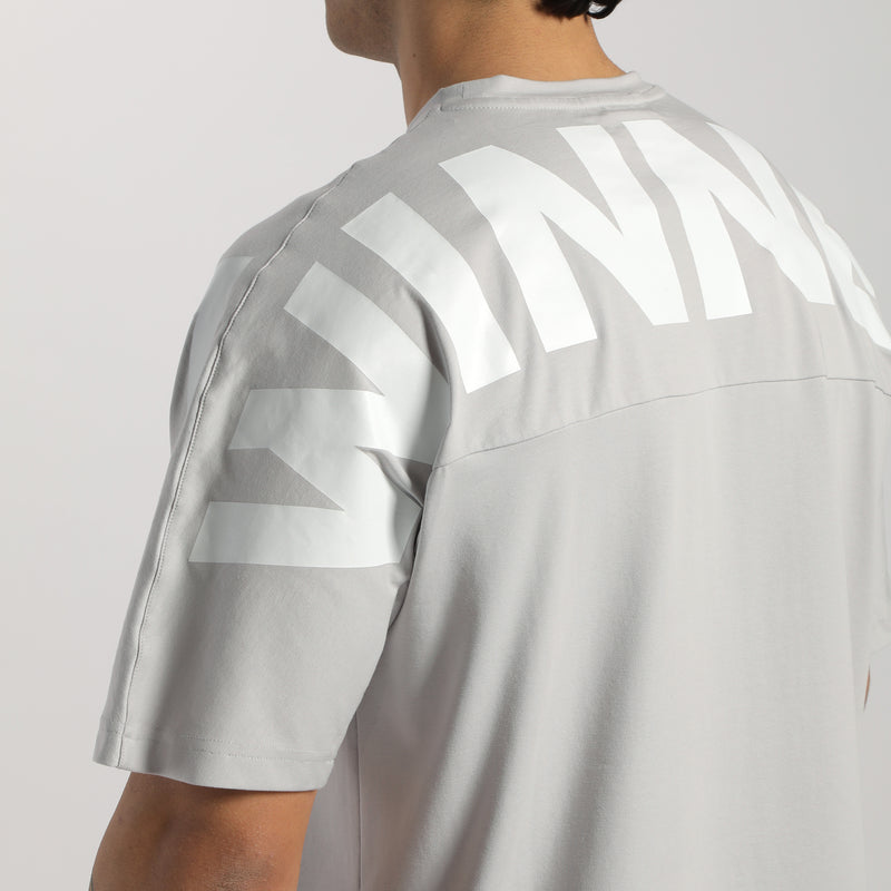 a back view for man wearing t-shirt  light grey with logo 