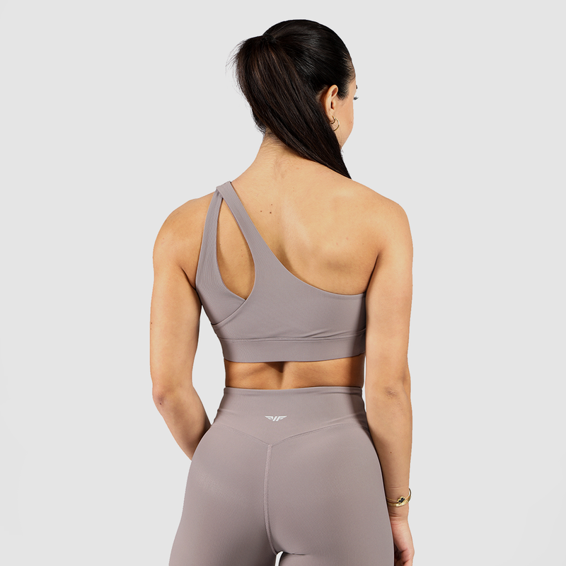 a back view  for woman wearing  a grey sports bra and legging ,plus logo and background  light grey 