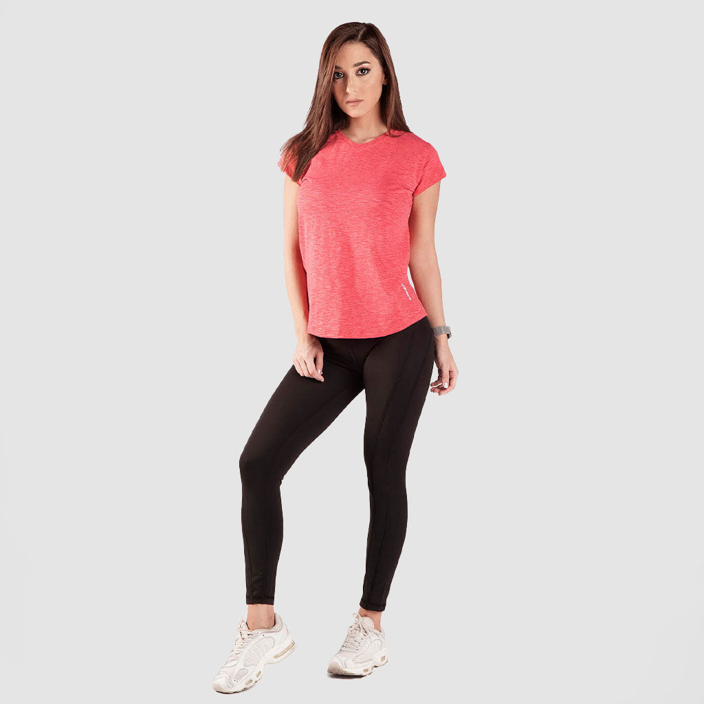 a fit woman stand with pose ,she wearing t-shirt marl candy red with legging  black  and shoes white ,plus the background is light grey 