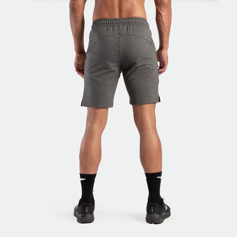 a back view for fit man wearing short marl dark grey with socks and shoes black 