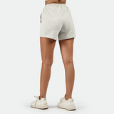 a back view for fit woman wearing  short marl light grey with shoes white ,plus the background is light grey 