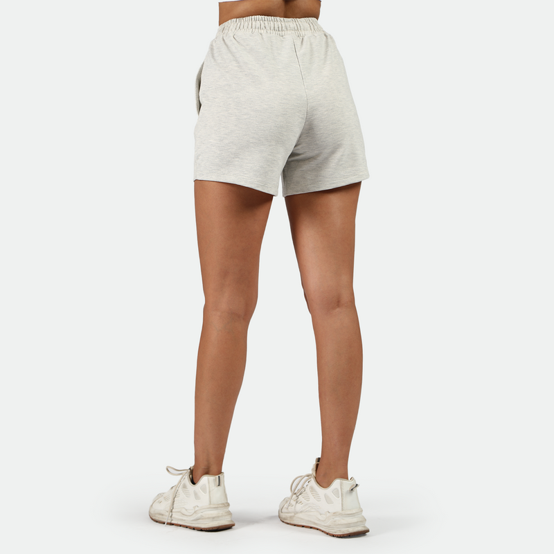 a back view for fit woman wearing  short marl light grey with shoes white ,plus the background is light grey 