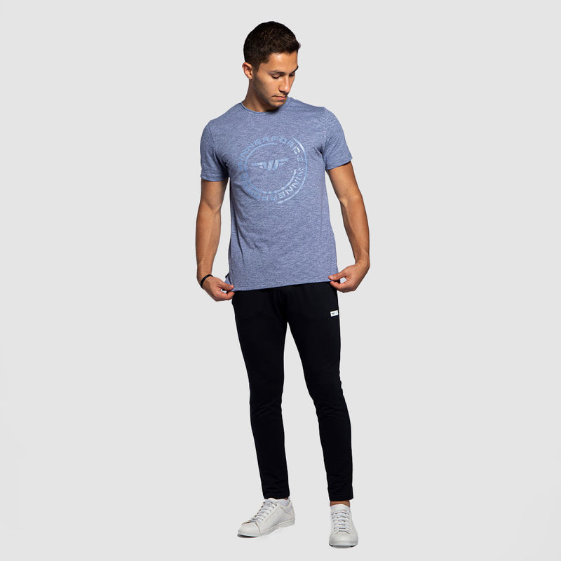 a fit man wearing t-shirt marl blue  with pants black , plus shoes white 