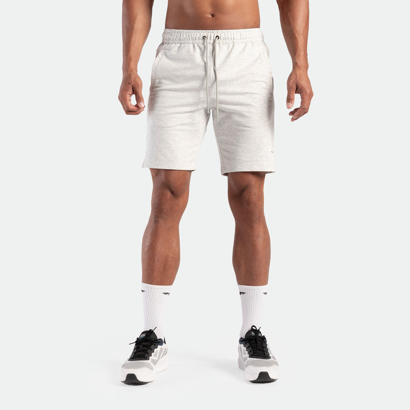 a fit man wearing short marl light grey  with socks white and shoes 