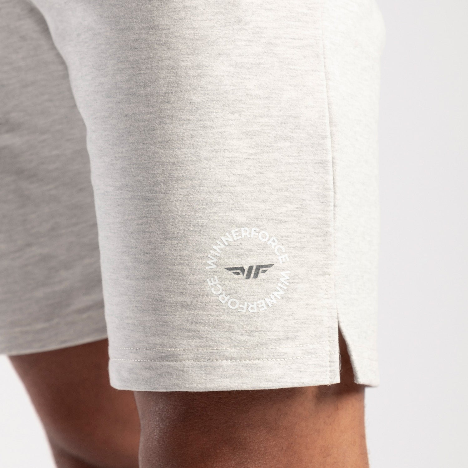 close up view for fit man wearing short marl light grey with logo 