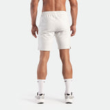 a back view for fit man wearing short marl light grey with socks white and shoes white 