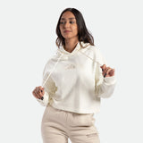 a fit woman wearing  hoodie  marshmallow with pants beige  