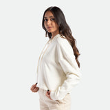 a fit woman stand at right  and wearing hoodie marshmallow with pants beige 