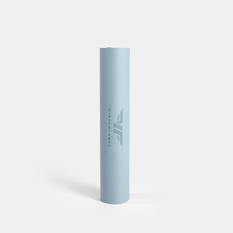 A rolled-up light blue yoga mat with "Winnerforce" and a logo printed on it, standing upright on a white background, conveying a clean and minimalist feel.