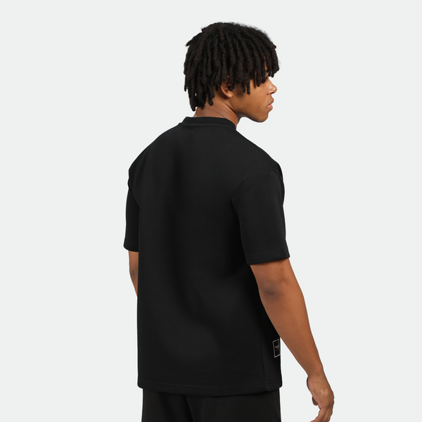a back view for  fit man wearing matching set black ,t-shirt and short 